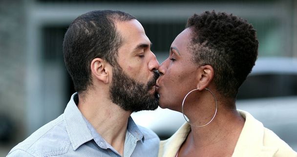 Interracial couple kissing each other, African wife and hispanic husband kiss outside - Foto, afbeelding