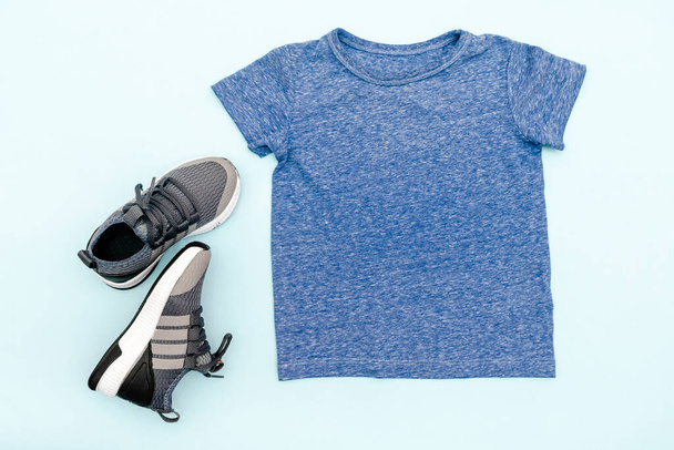 Summer babies blue gray clothes and accessories with t shirt,sneakers. Modern fashion kids casual outfit.Set of children's clothing for spring. Flat lay, top view,overhead,mockup. - Photo, Image