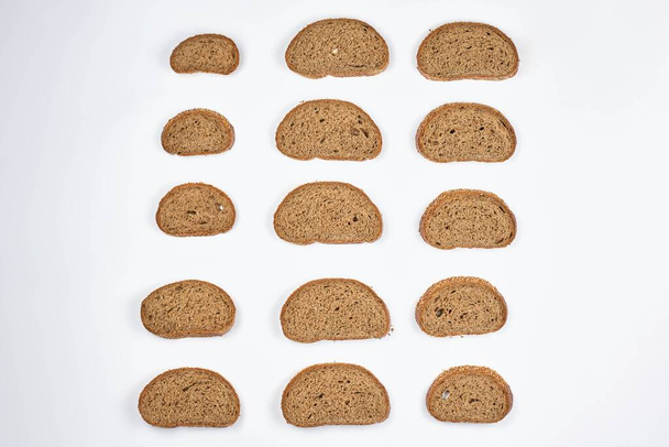 A beautiful arrangement of bread slices on white background - Foto, afbeelding