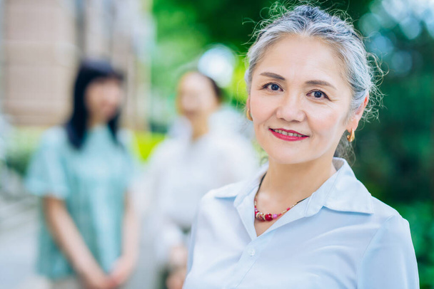 Asian gray-haired woman portrait outdoors - Foto, Imagen