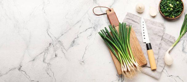 Composition with green onion on light background with space for text, top view - Fotografie, Obrázek