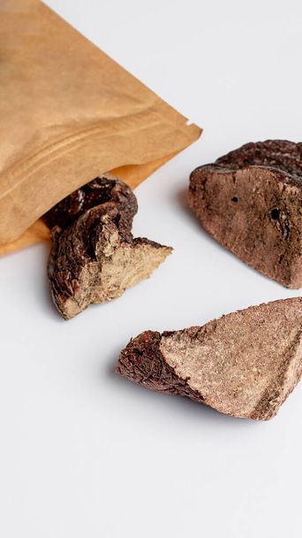 Natural dried treats for dogs. Treats for rewarding and training dogs. Dried meat products for dogs. Animal care.Selective focus. Advertisement for dog treats. beef lung. - Foto, Bild