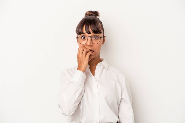 Young mixed race business woman isolated on white background  biting fingernails, nervous and very anxious. - Photo, Image
