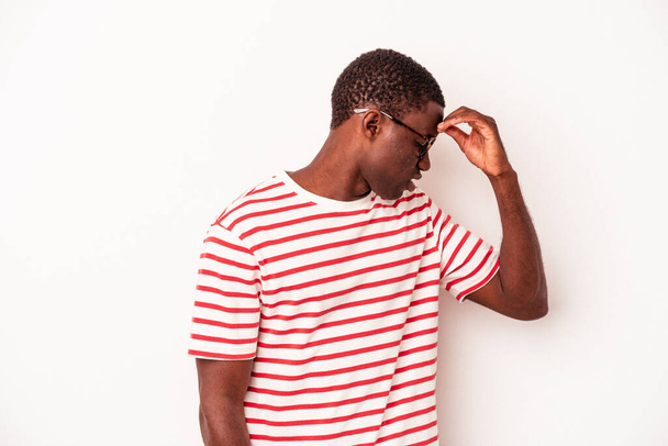 Giovane uomo afroamericano isolato su sfondo bianco con mal di testa, toccando la parte anteriore del viso. - Foto, immagini
