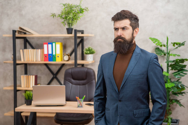 serious mature entrepreneur in jacket standing at office with copy space, business. - Photo, Image