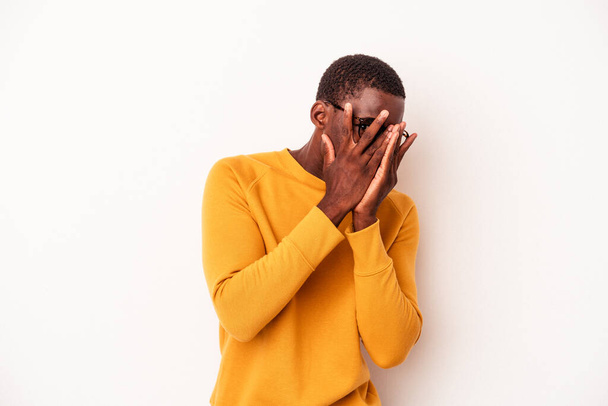 Young African American man isolated on white background blink through fingers frightened and nervous. - Φωτογραφία, εικόνα