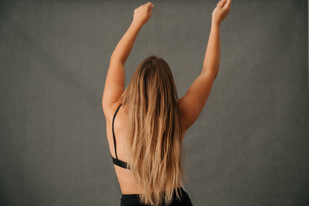 Close up of back view of Caucasian female with long blond hair in the studio. High quality photo - Foto, Bild