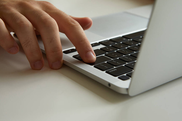 a man working on a laptop, his hands close up - Φωτογραφία, εικόνα