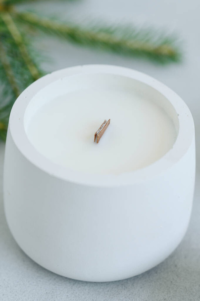 Handmade Candle in Plaster Cache-pot Close-up. Place on Label. Concept of Warmth and Comfort in House. - Foto, Imagen