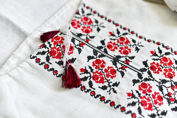 handmade vyshyvanka shirt embroidered with red and black threads. National clothing of Ukraine. Close-up shot, copy space. - Zdjęcie, obraz