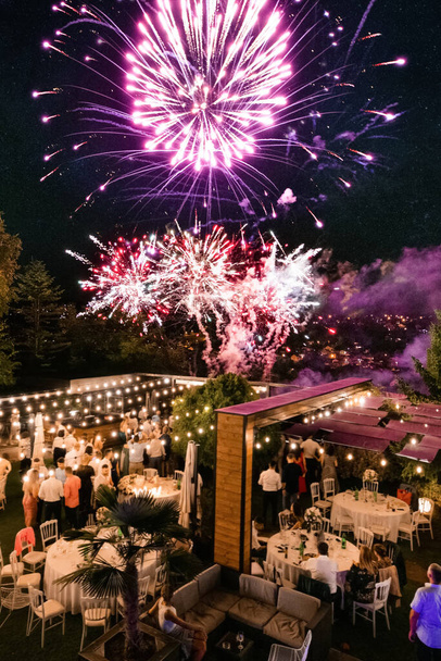 Multi-colored fireworks in the sky at the wedding reception at night.  - Foto, imagen