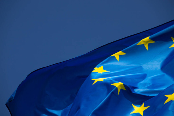 European flag in the wind with a beautiful blue sky in the background. Place to place text - Foto, afbeelding