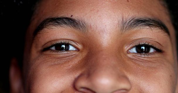 Mixed race young boy closing eyes in meditation, child opening eyes smiling - Photo, image