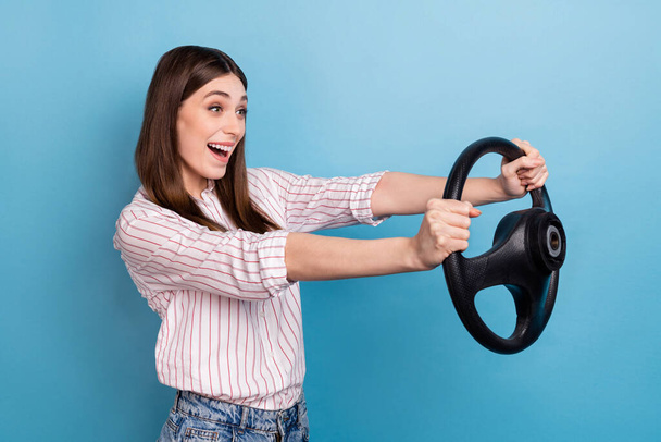 Profile side view portrait of attractive ecstatic girl driving having fun isolated over vibrant blue color background. - Foto, Imagem