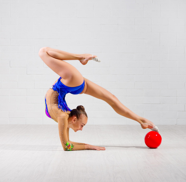 Girl is engaged in art gymnastics - Фото, изображение