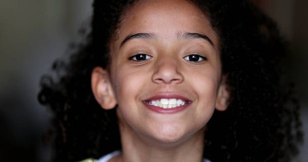 Mixed race little girl child smiling at camera portrait face - Valokuva, kuva