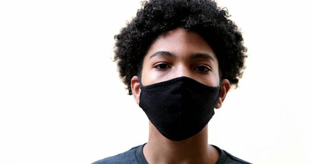 Mixed race kid putting covid-19 face mask on - Fotografie, Obrázek