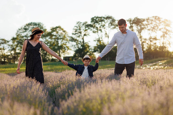 Family walking with son in a field with lavender - Fotografie, Obrázek