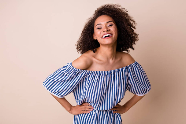 Portrait of pretty positive lady put arms waist toothy smile laughing isolated on beige color background. - Foto, imagen