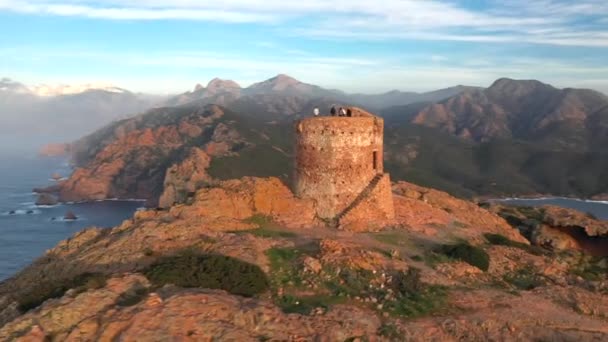 Aerial view of the Capo Rosso Tower in Corsica. Drone view of the Turghiu tower at sunset in France. Mediterranean Sea coastline - Imágenes, Vídeo