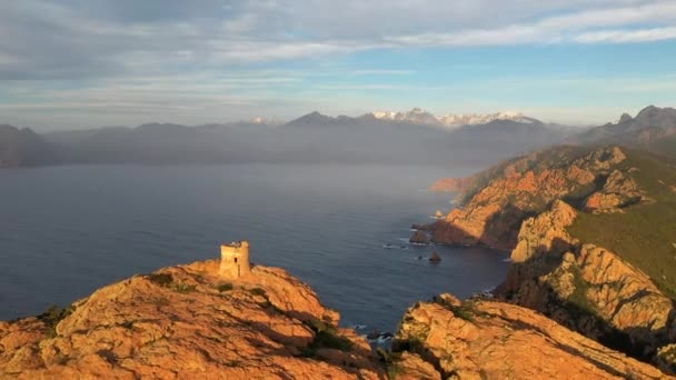 Aerial view of the Capo Rosso Tower in Corsica. Drone view of the Turghiu tower at sunset in France. Mediterranean Sea coastline - Video, Çekim