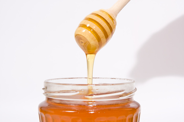 Honey in wooden stick - Фото, изображение