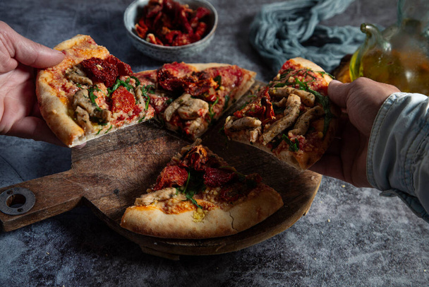 Diverse colleagues or friends take slices of vegan pizza and enjoy dinner. - Valokuva, kuva