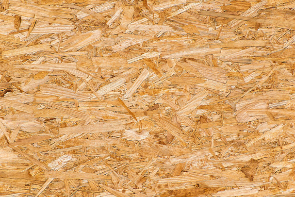 OSB plate area composed of many pressed chips Texture, background for further work. - Foto, Bild