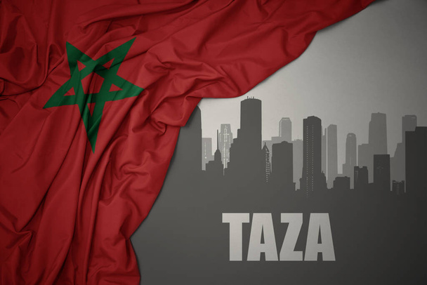 silueta abstracta de la ciudad con texto Taza cerca ondeando colorida bandera nacional de morocco sobre un fondo gris. Ilustración 3D - Foto, Imagen