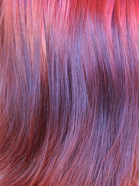 dyed red female hair closeup, texture for background. - Zdjęcie, obraz