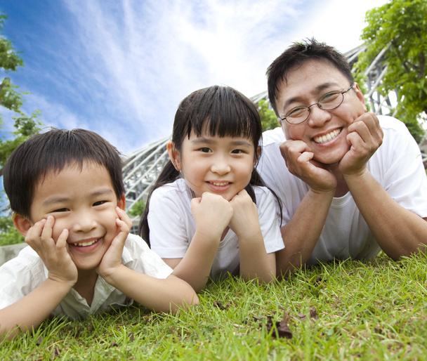 Happy family lying on the grass.father with son and daughter - Photo, Image