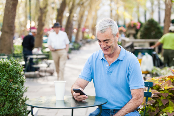 American Senior Man with Mobile Phone at Park - Photo, Image