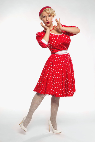 Young beautiful blonde in red dress pin-up in the studio - Fotoğraf, Görsel