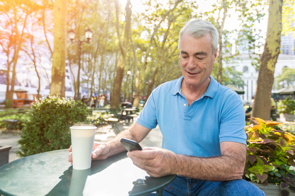 American Senior Man with Mobile Phone at Park - Фото, изображение