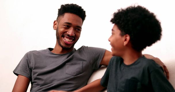 Two brothers talk interaction, black african siblings in conversation - Fotó, kép