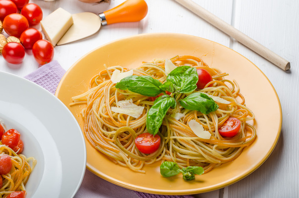 Lemon pasta with cherry tomatoes, basil and nuts - Photo, Image