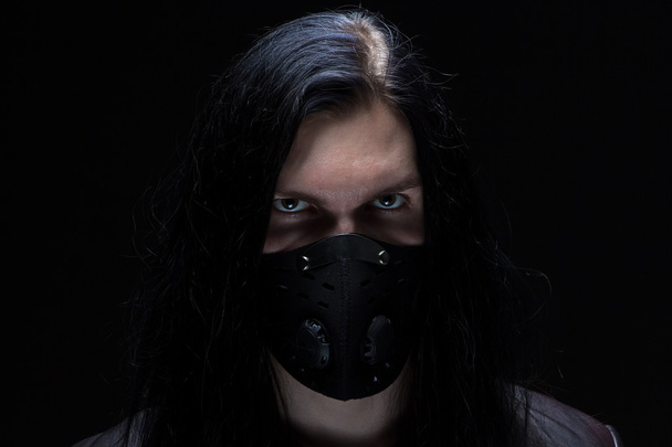 Image of the man with long hair in mask - Photo, Image