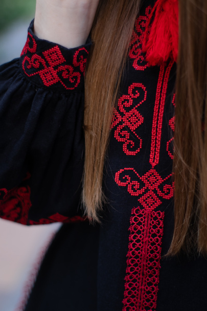 close up of national traditional ukrainian clothes. details of woman in embroidered dress. unrecognizable person. - Foto, Imagem