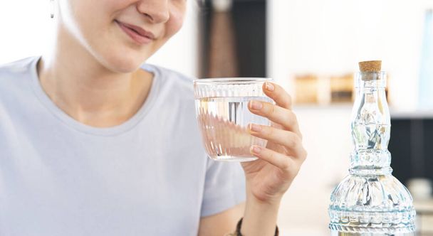 Mujer bebiendo un vaso de agua fresca en casa - Foto, Imagen
