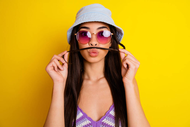 Portrait of cute charming female with fake mustache fooling around flirting with boyfriend isolated on yellow color background. - Zdjęcie, obraz
