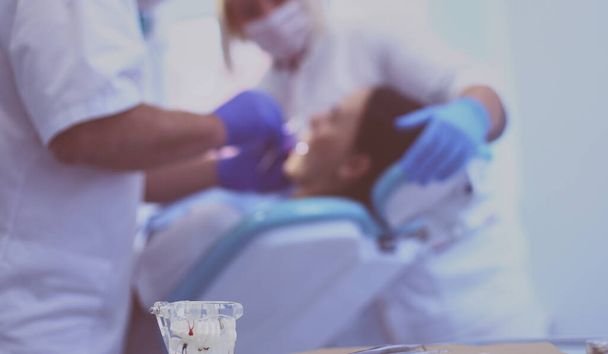 Dentist and his assistant carrying out a thorough examination. - Foto, Imagen