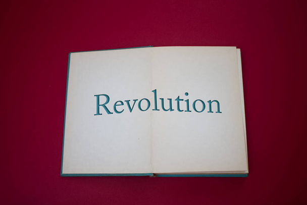 Revolution word in opened book with vintage, natural patterns old antique paper design. - Photo, Image
