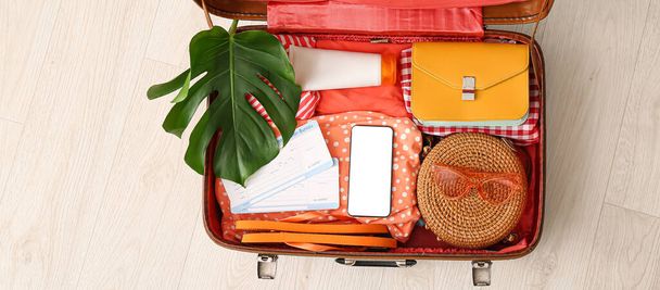 Packed suitcase on floor, top view. Travel concept - Foto, Imagen