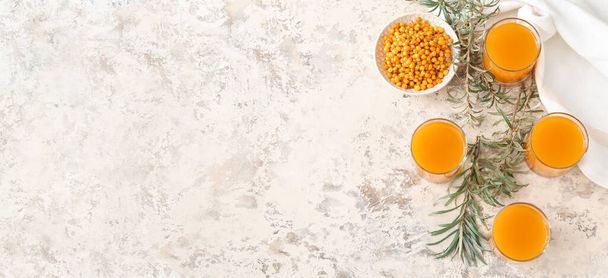 Glasses of healthy sea buckthorn juice on grunge background with space for text - Φωτογραφία, εικόνα