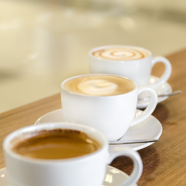 Three cups of coffe in diagonal line - Foto, Bild
