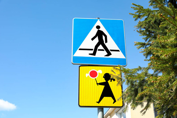 Different traffic signs against blue sky, space for text - Foto, imagen