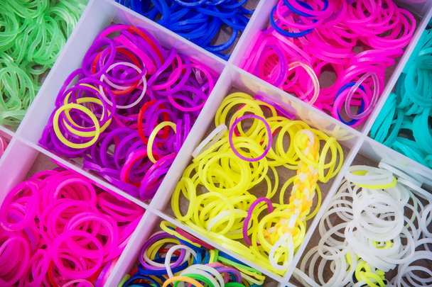 Box with many colorful rubber bands for rainbow loom - Photo, Image