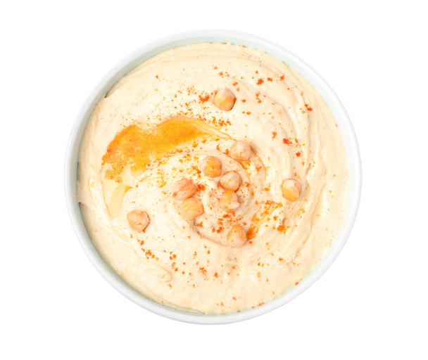 Tasty hummus with garnish in bowl isolated on white, top view - Zdjęcie, obraz