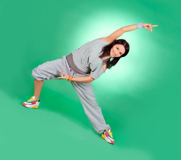 Attractive young female in stretching over green - Foto, Imagen