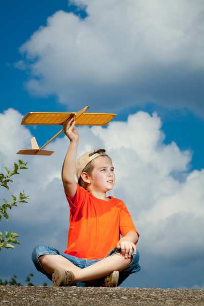 Little boy playing with airplane - Photo, Image